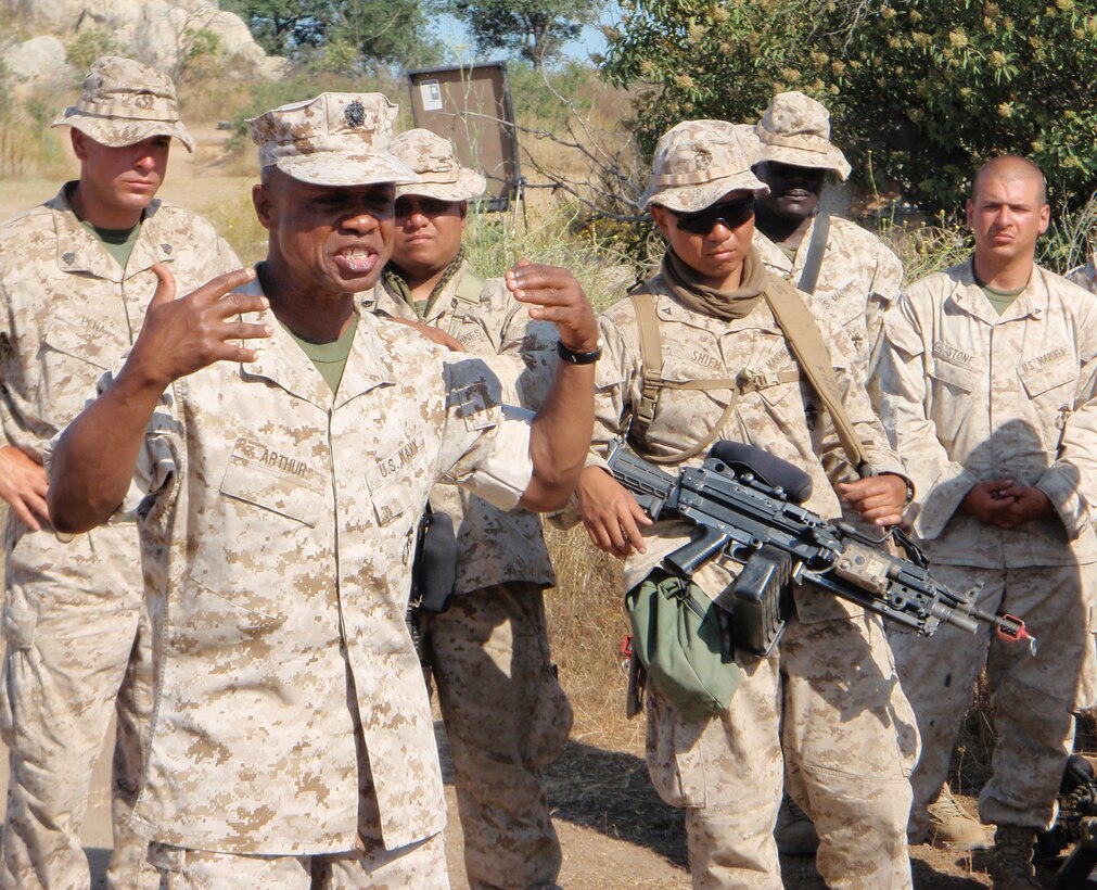 Lt. Cmdr. Kobena Arthur gives a motivational speech to Marines and Sailors at Camp Pendleton, Calif. on June 17, 2008.  Arthur exclaimed, "Keep on!" to which the troops responded, "Keeping on!" This adage has become ubiquitous throughout the battalion as they head into the final phase of their pre-deployment training.